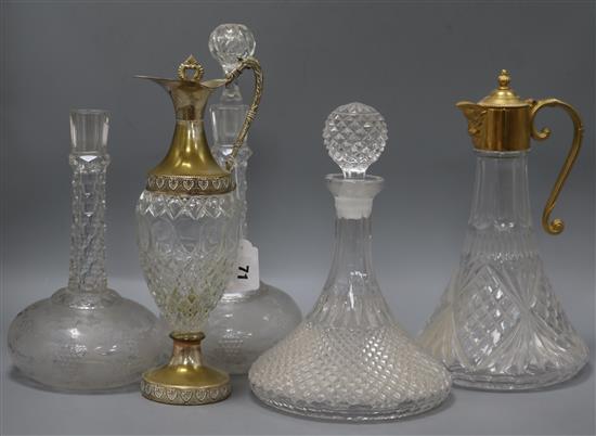 Three decanters and two claret jugs